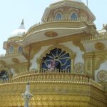 Vibrant temple building with golden details, praying here is one of the most refreshing things to do in Shirdi