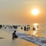 A picture of some tourists enjoying sunrise–one of the best things to do in Thiruchendur