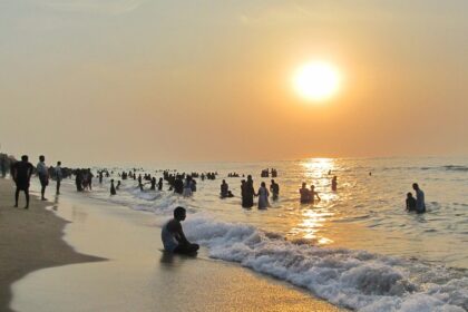 A picture of some tourists enjoying sunrise–one of the best things to do in Thiruchendur