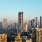 A view of the South Mumbai skyline, featuring skyscrapers and city lights.