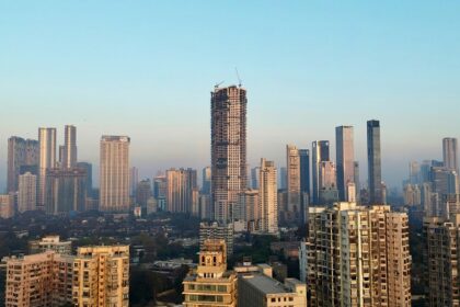 A view of the South Mumbai skyline, featuring skyscrapers and city lights.