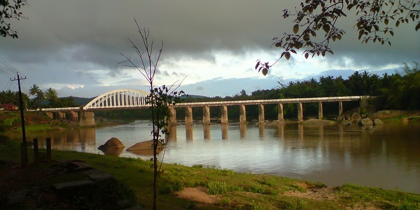Captivating view of Tunga Bridge in Thirthahalli against the dark cloudy sky