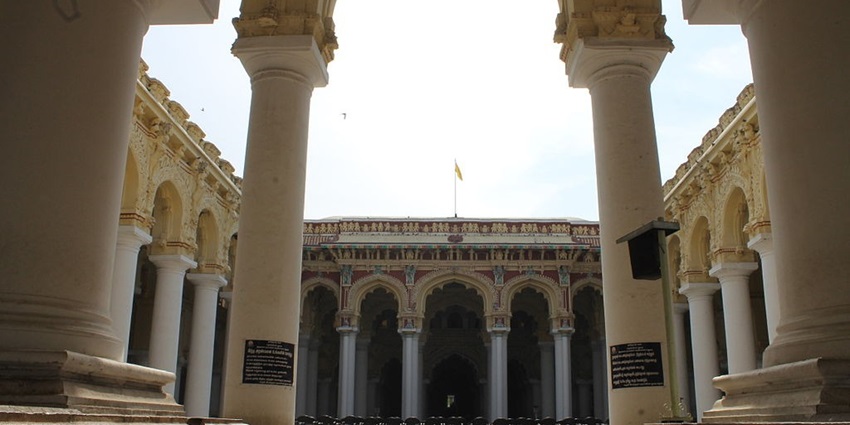 A view of Thirumalai Nayak Mahal, a famous palace near Meenakshi Temple with tall arches.