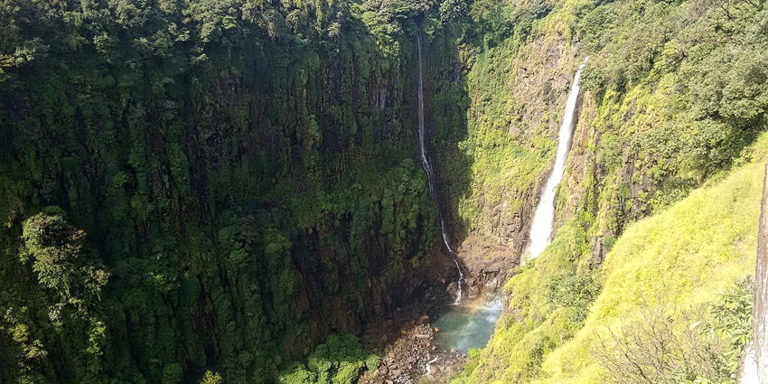 Thoseghar Waterfalls cascading through greenery and rocky terrain near Kalyangad Fort.