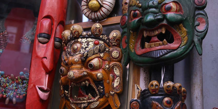 Image of traditional items and masks in a Tibetan shop, one can buy as souvenir
