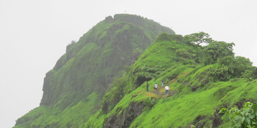 Tikona Fort, a triangular hilltop site, is among the best places to visit in Tamhini Ghat.