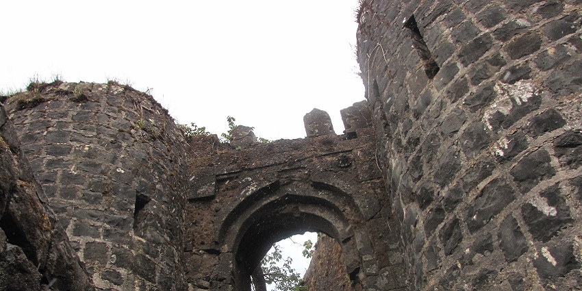 An image of the triangular-shaped Tikona Fort with panoramic views.