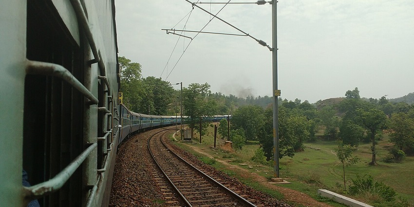 Beautiful view from a passenger train passing through the lush green forest in Odisha.
