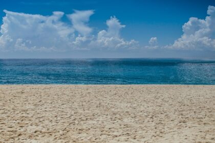 A panoramic view of Mandwa Beach with people engaging in various water sports.