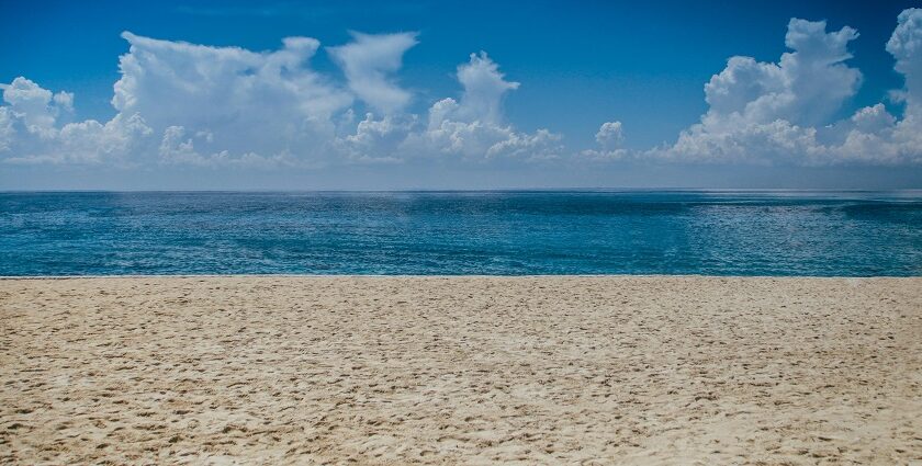 A panoramic view of Mandwa Beach with people engaging in various water sports.