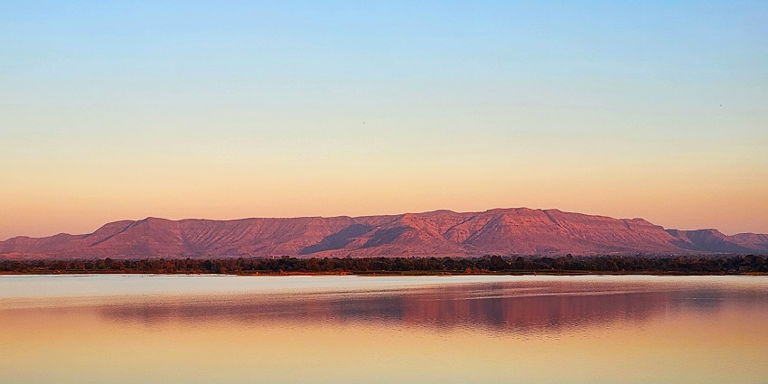 Magical view pink glow during sunset in the Satpura ranges from a lake in Maharashtra