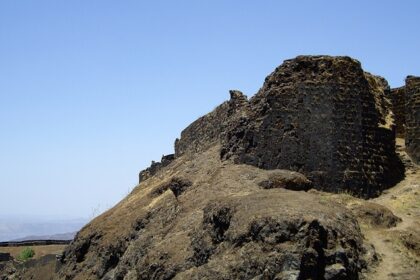 Entrance of Torna Fort, showcasing its ancient stone structure and natural surroundings.