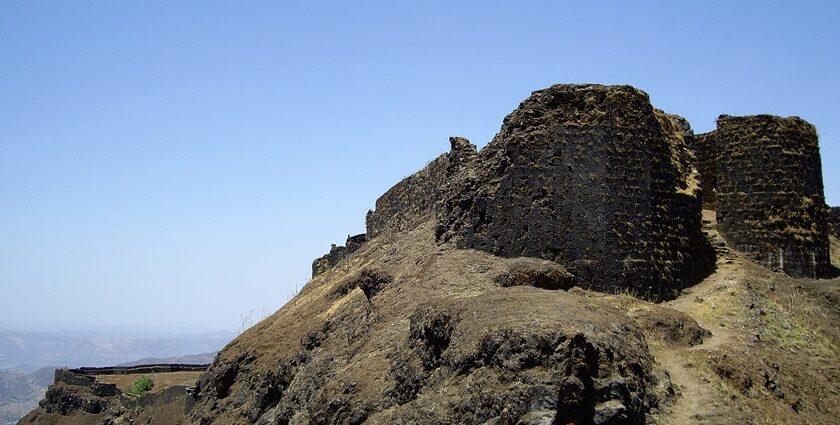 Entrance of Torna Fort, showcasing its ancient stone structure and natural surroundings.