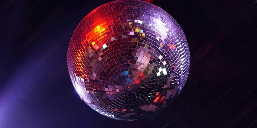 Image of a disco ball with colourful lights on the wall - enjoy a rave party in Toy Room, Delhi
