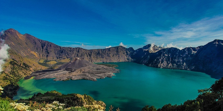 A serene view of Mount Rinjani and Lake Segara Anak inside it situated in Indonesia.