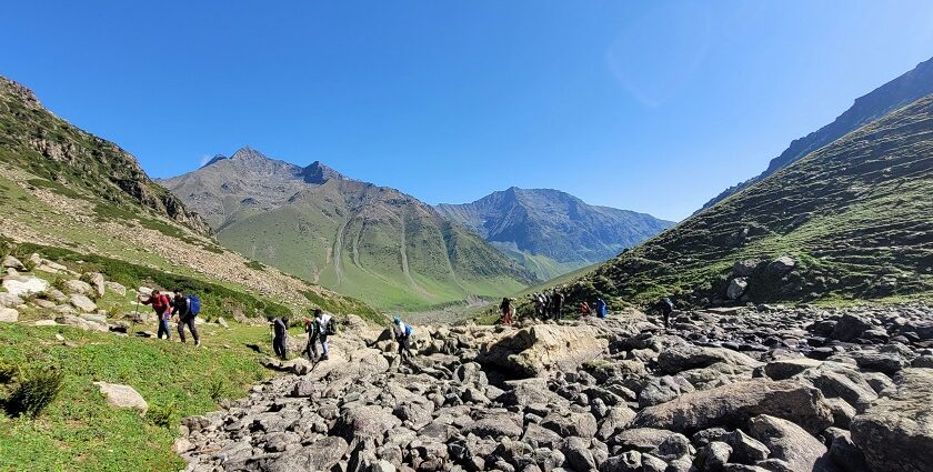 A picture of a trekking trail near Mumbai, ft. greenery, terrain, and a path into the hills.