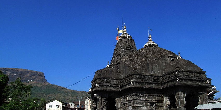 Trimbakeshwar Temple's facade features intricate carvings and imposing spires