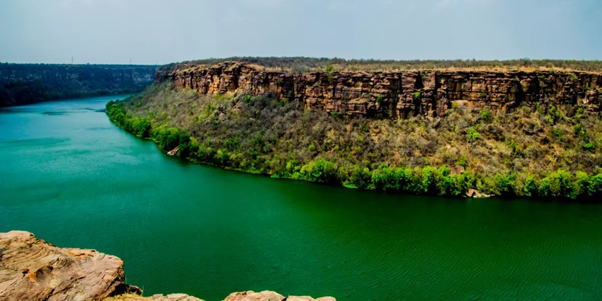Steep cliffs carved by the Chambal River form a dramatic green-water gorge