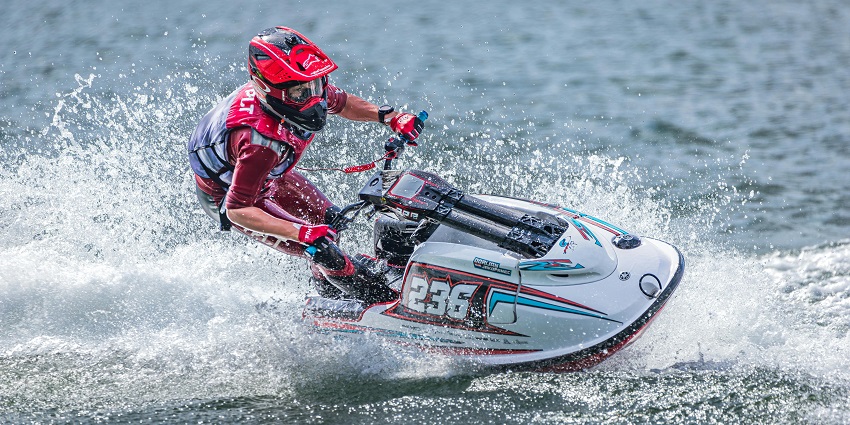 A man on a jet ski, splashing the waves in an adventurous manner, making it one of the best things to do in Madh Island.