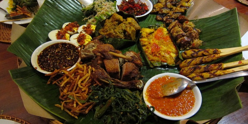 Image of Bali traditional food served on a banana leaf in vibrant colours