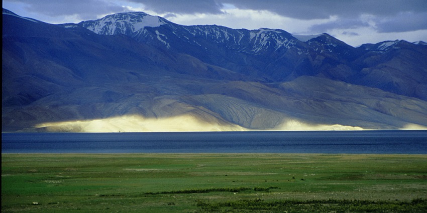 View of the lake with snow covered peaks in the background