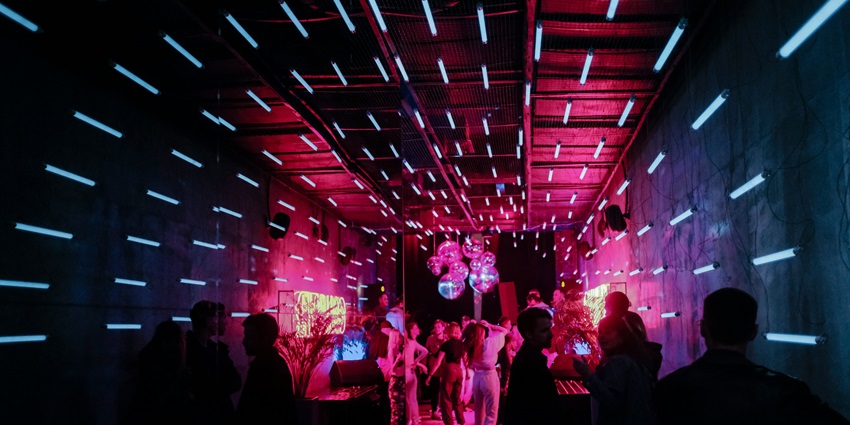 Image of people dancing in a club under the vibrant disco lights at party places in Singapore