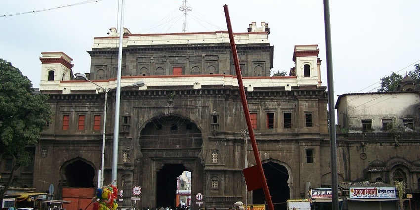 Exterior view of Tulja Bhavani Temple, showcasing intricate architecture and devotees