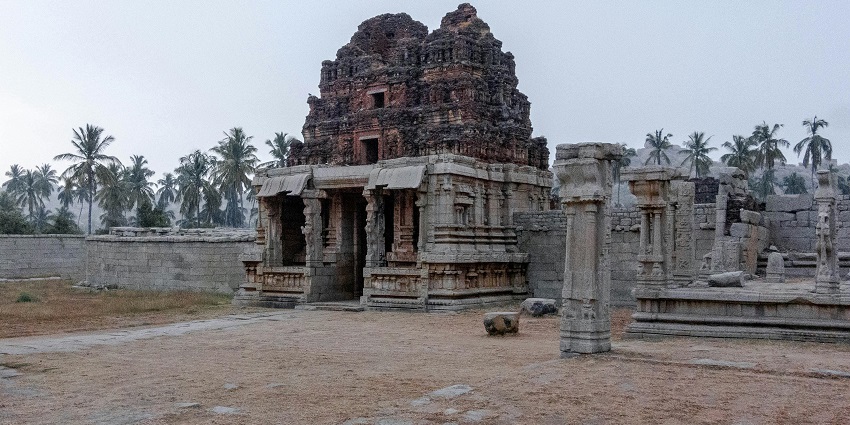 An ancient architectural temple ruins in India, featuring intricately carved stone structures.
