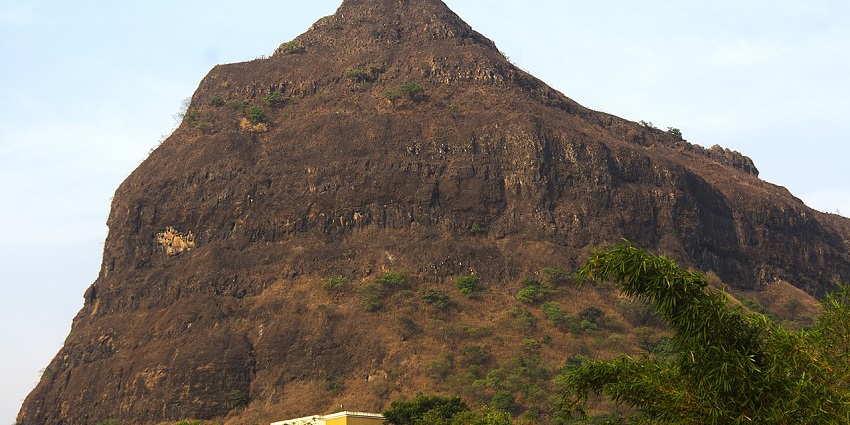Tung fort on a hill surrounded by green trees, one of the popular destinations near Morgiri Fort.