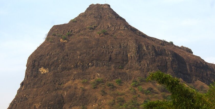 A view of Tung Fort bathed in sunlight, surrounded by green hills and a clear blue sky.