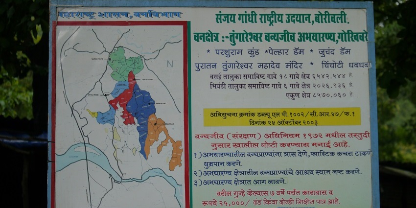Signage of biodiverse sanctuary, lush landscapes, rich wildlife, scenic trails.