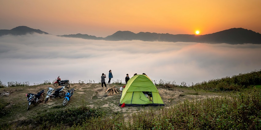 Two different types of camps setup near the woods to depict variation in tents.