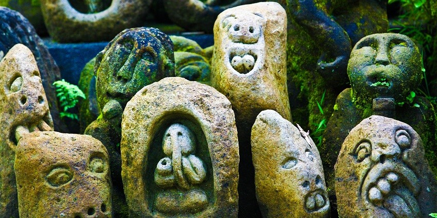 Colourful Balinese stone carvings depicting animals and other figures.