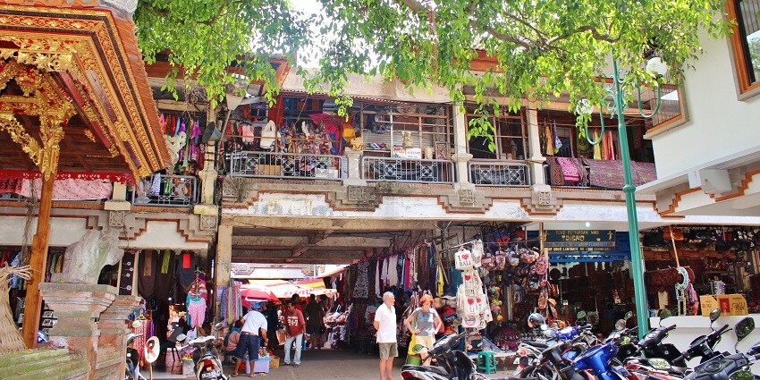 Panoramic view of marketplace at Udub in Bali shops lined with colourful clothes and bags, one of the nice places to visit in Bali.