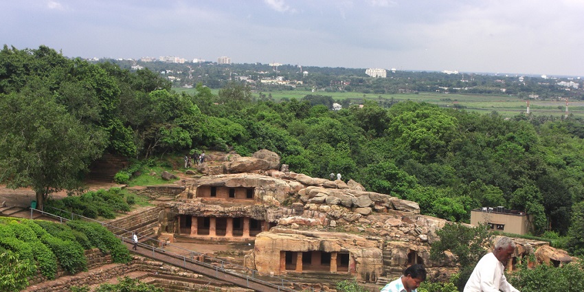 Two men and one woman climbing at the top of Khandagiri Hills of the Cave Complex near Atri hot spring