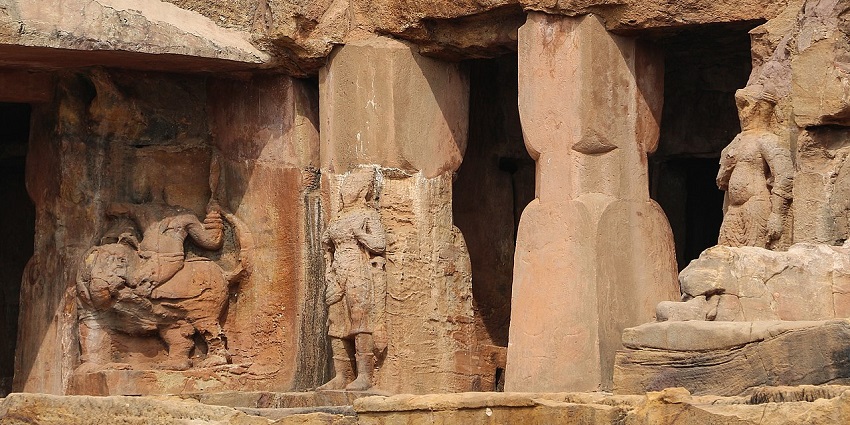 An outer view of the Udayagiri Caves with the ancient stone sculpture outside it