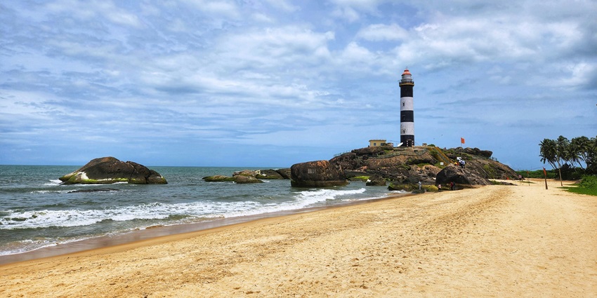 A scenic view of the shimmering blue waters and golden sandy beaches in Udupi.