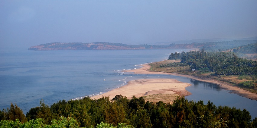 Scenic view of Ganpatipule Beach with golden sand and clear waters.