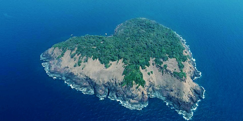 Aerial view of an Island, showcasing its rocky coastline and blue waters.