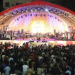 An image of a vibrant music festival in Vadodara with crowds enjoying live performances.