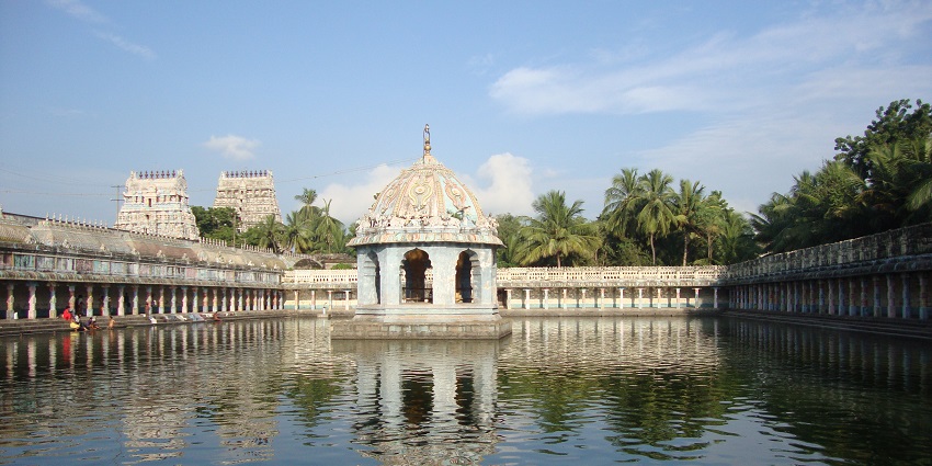 Vaitheeswaran Koil temple with colourful gopuram and architectural details along a lake.