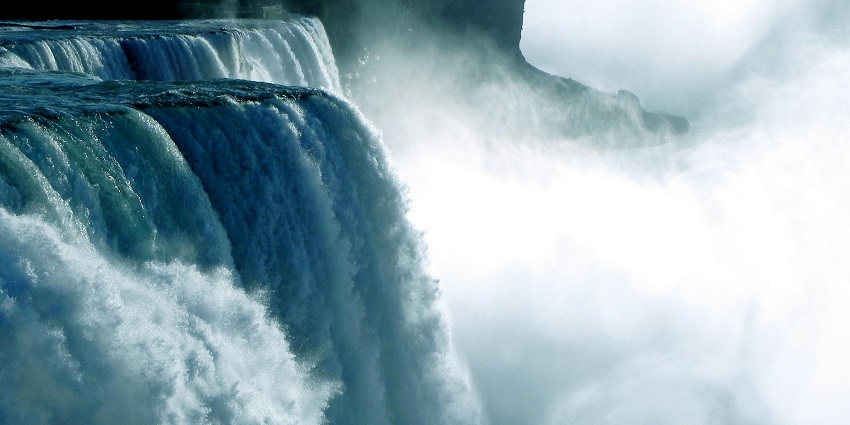 Glorious waterfalls cascading under the bright sun, creating a mesmerising scene.
