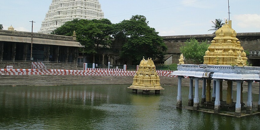 Majestic Varadaraja Perumal Temple in Kanchipuram, Tamil Nadu, a pond in the foreground.