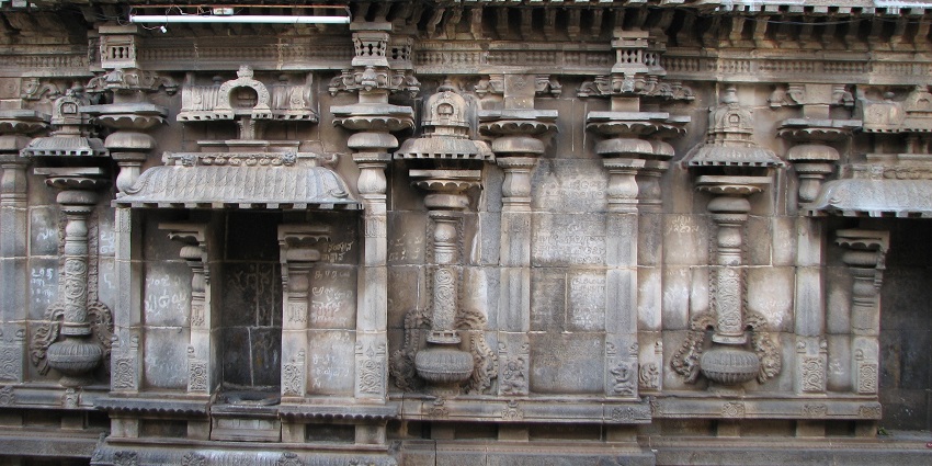 Ornate stone carvings on the side walls of the sanctum at Varadaraja Perumal Temple