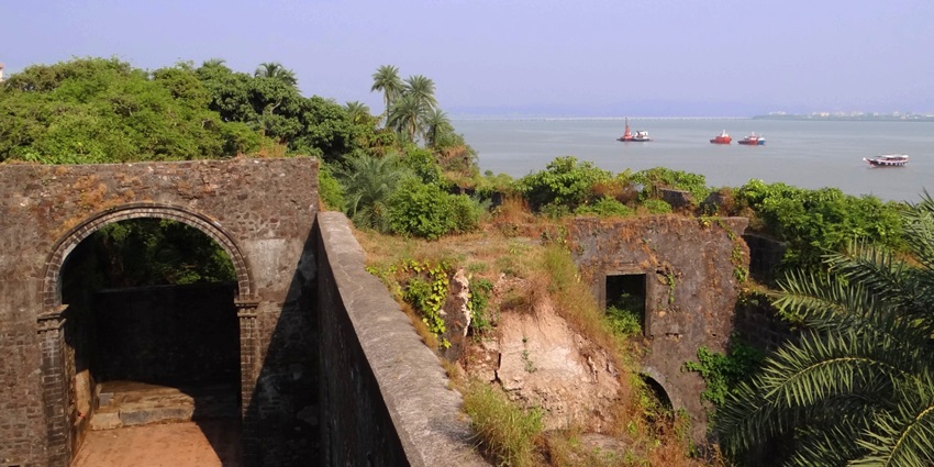 The scenic view of the beautiful Vasai creek, surrounded by ancient ruins and greenery.