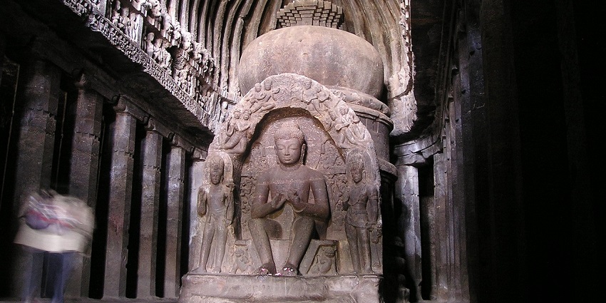 A peaceful Buddha shrine inside a beautifully adorned Indian temple.