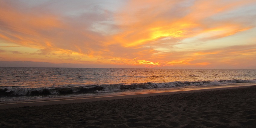 A beautiful image of Velas Beach with vibrant sunset hues