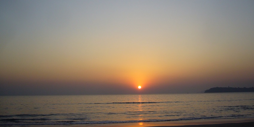 panoramic view of a sunset at the Velsao beach making vibrant hues in the sky