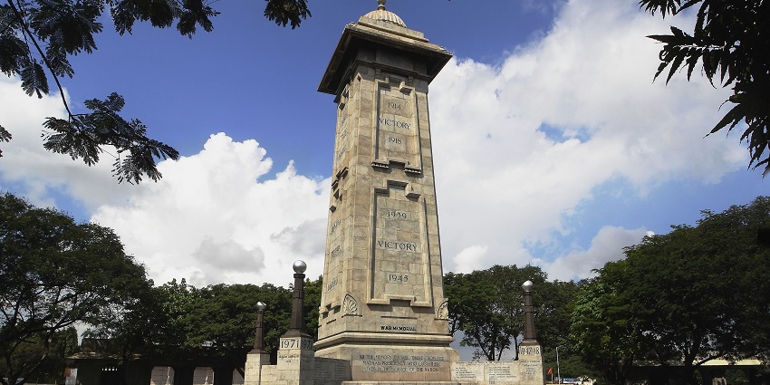 A glimpse of the majestic Victory War Memorial surrounded by lush green vegetation.