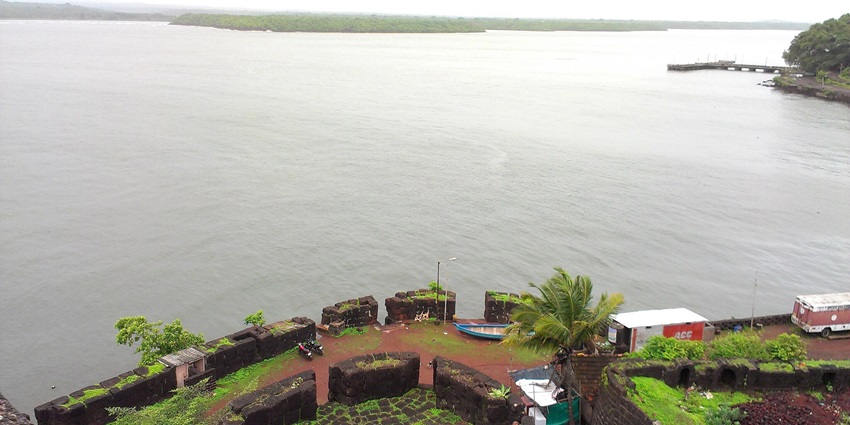 Vijaydurg Fort, a historic tourist attraction in Maharashtra, surrounded by calm waters.